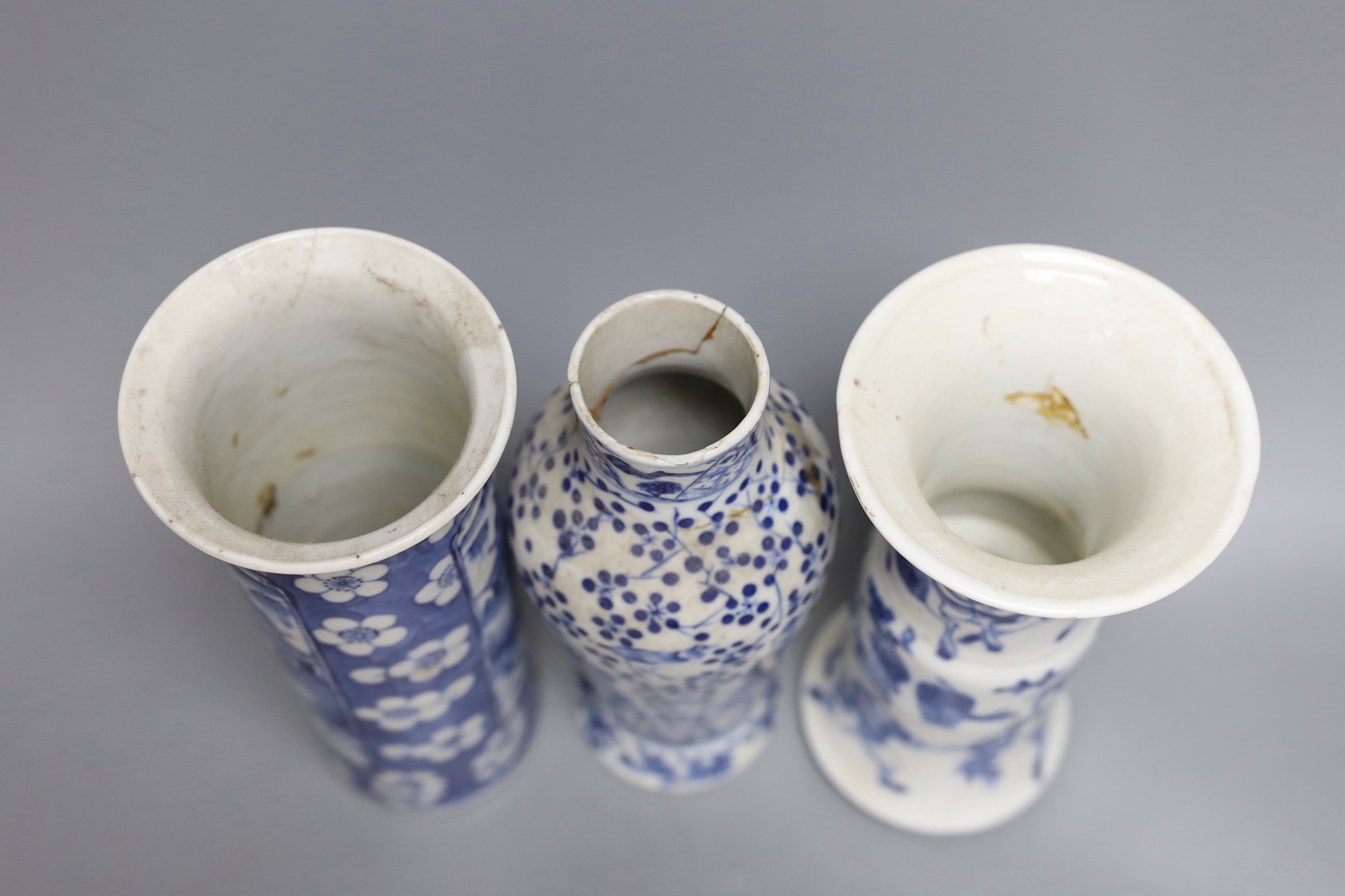 A Chinese blue and white sleeve vase and two other similar vases, late Qing dynasty, tallest 21 cms high